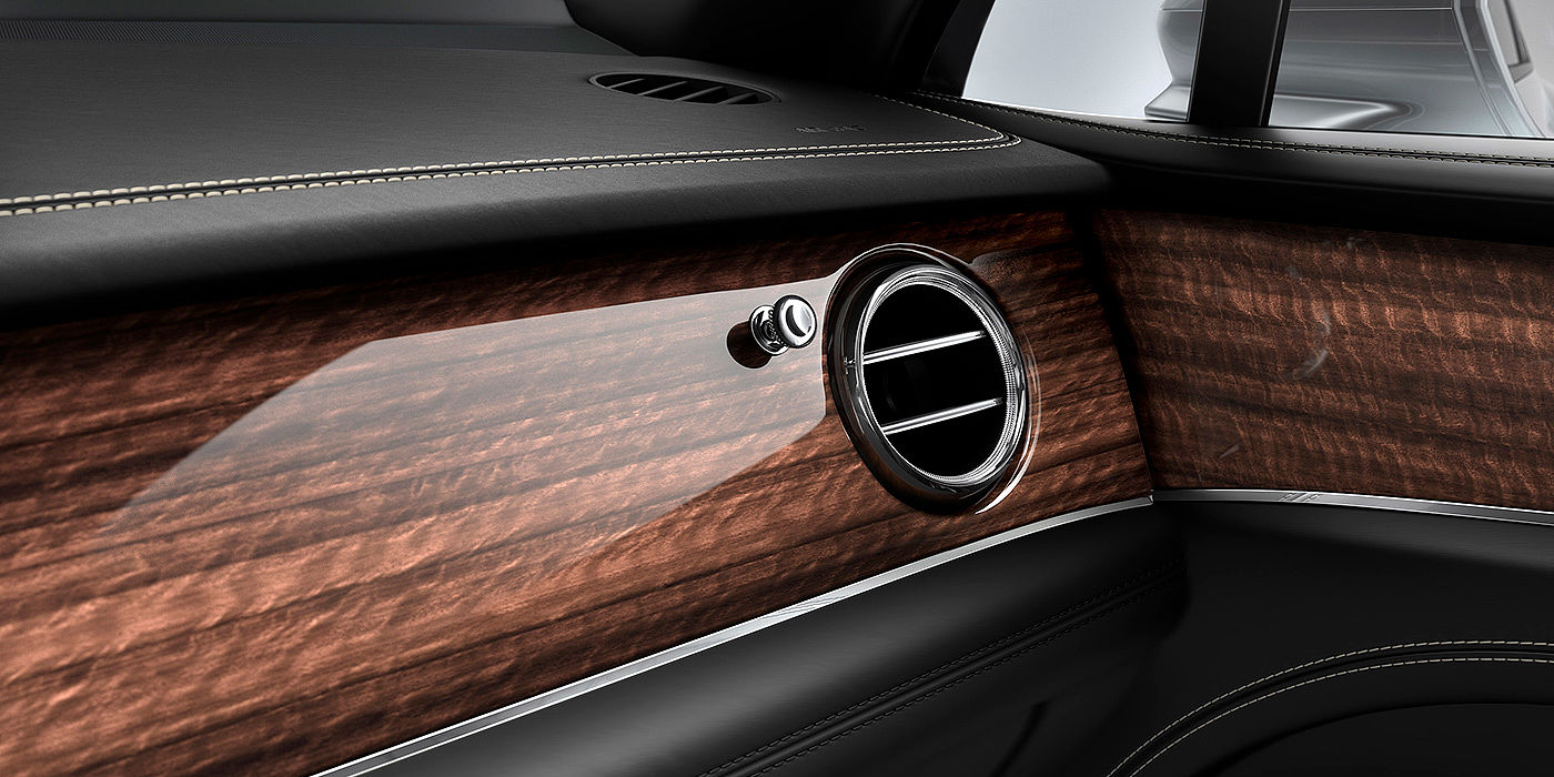 Bentley Ho Chi Minh Bentley Bentayga front interior Crown Cut Walnut veneer and chrome air vent.