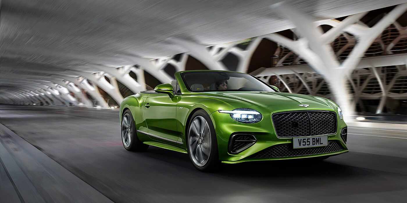 Bentley Ho Chi Minh Bentley New Continental GTC Speed V8 hybrid driving dynamically at night in Tourmaline Green paint