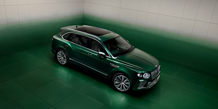 Bentley Bentayga EWB SUV in ¾ high-angle view with Light Emerald Mulliner heritage exterior paint, Atelier Edition version, showcasing luxury and sophistication.