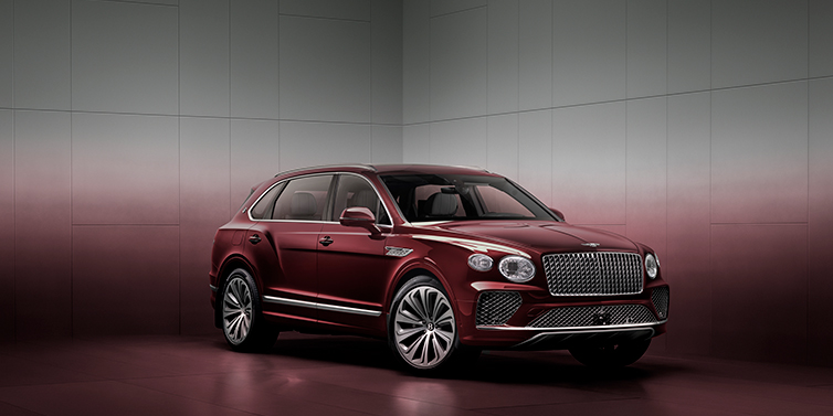 Bentley Bentayga EWB SUV in 3/4 view with Rubino Mulliner heritage exterior paint, Atelier Edition version, showcasing refinement and elegance.